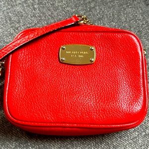 Orange MK cross body purse.